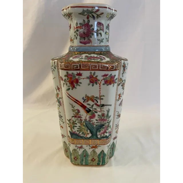 Beautiful Chinese vase with birds, butterflies, flowers and leaves. Pretty colors over a white vase include pink, gold,...