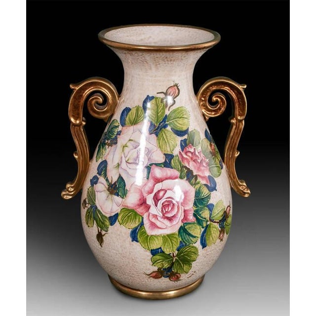 This handcrafted Italian ceramic vase features an elegant hand-painted rose motif in soft pink and ivory tones, framed by...