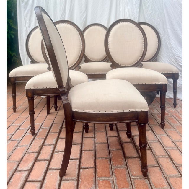 Elevate your dining room with this exceptional set of six Louis XVI- inspired medallion-back dining side chairs from...