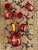 Vintage Italian-style glassware set featuring a rich ruby-red glass with elaborate gold filigree and floral decoration....