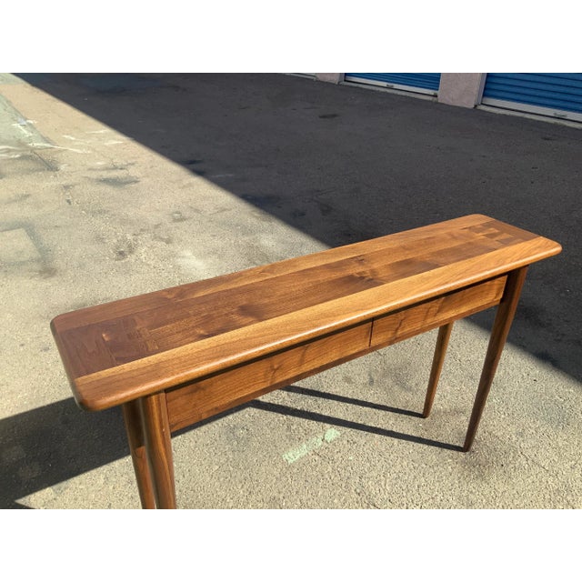 Modern walnut console table. Table is quite unique and ready to enjoy. Table has 2 drawers. Has a design on end of each...