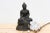 This captivating patinated Buddha figure, measuring 8 inches wide, 5 inches deep, and 11 inches high, embodies profound...