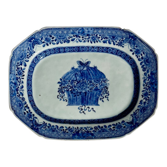 A Chinese export porcelain platter from the Qing Dynasty, decorated in underglaze blue with a lidded basket overflowing...