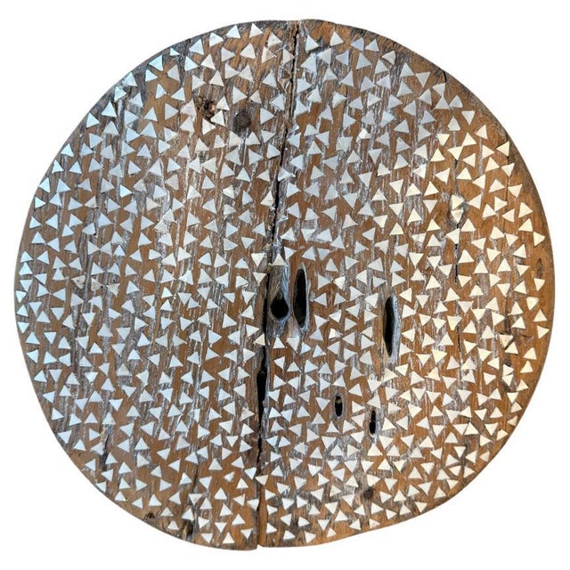 Hand cut pieces of mother of pearl shell are carefully inlaid into this antique teak wood wheel. Great as an art...