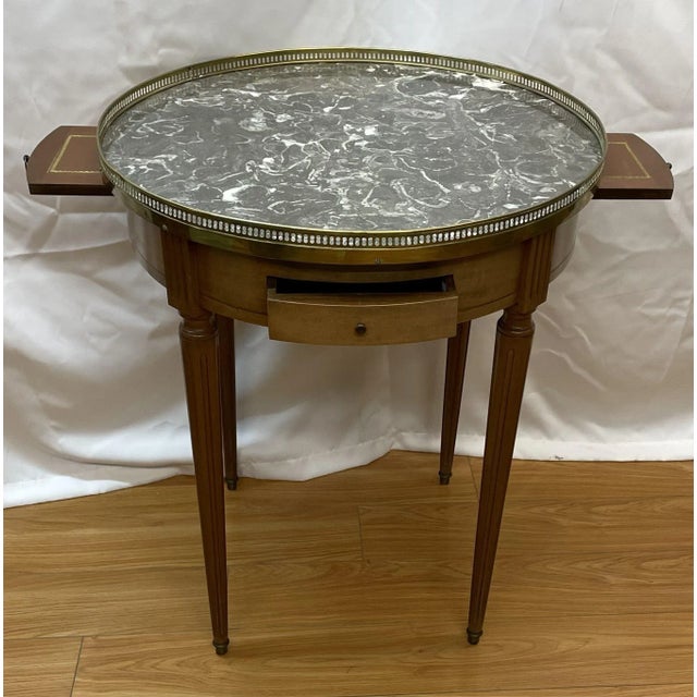Circa 1940's Bouillotte Marble Top Table with pull out to leather glass holders and brass reticulated surround.