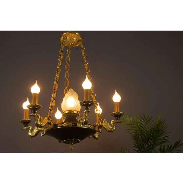 This beautiful French Empire style chandelier features six bronze swan arms. Dark green painted body with decorative...