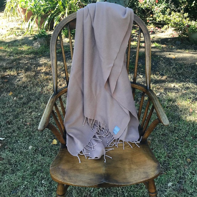 Luxurious, 100% felted knit cashmere blanket featured in a warm, neutral Honey tone with fringe. Generously sized, medium...