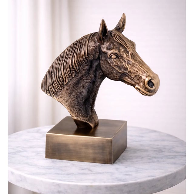 Add a bold statement of strength, elegance, and craftsmanship to your living space with this Antique Brass Finish Horse...