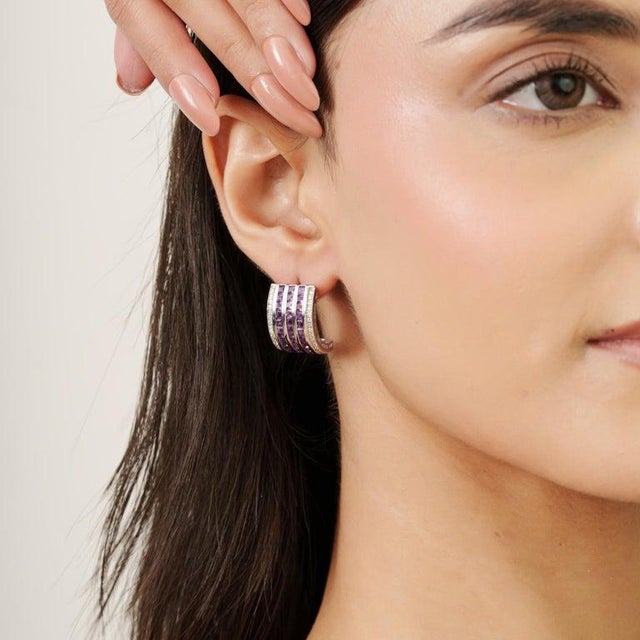 Featuring 2 mm amethyst gemstones with a total weight of 4.36 carats, these earrings are crafted in 925 sterling silver...