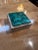 Indulge in the elegance of our Vintage Italian Travertine and Green Marble Ashtray, a captivating piece from the 1990s....