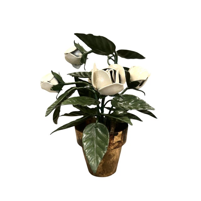 A charming, vintage tole floral arrangement. Features hand painted green leaves and stems with white blooms in a gilded...