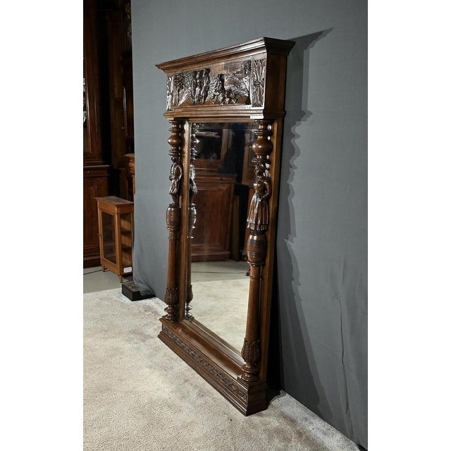 Large Breton Mirror composed of an original beveled mirror and a large sculpted frame. The latter is topped with a...