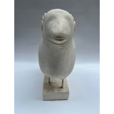 A single contemporary sculpture of a sheep mounted on a rectangular base with chalky white finish.