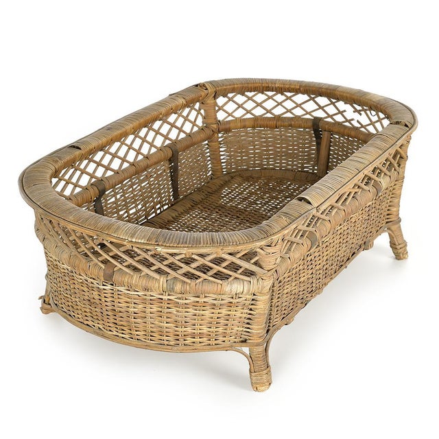 With its oval silhouette and its structure raised by pretty curved feet, this woven wicker basket combines rustic...