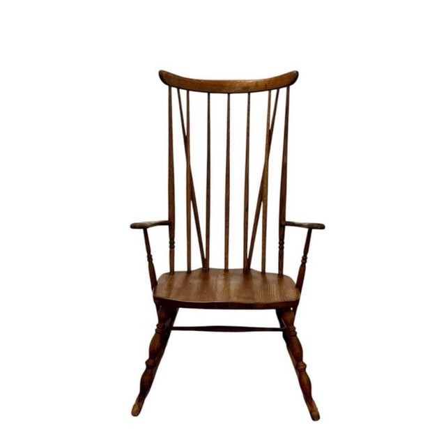 Windsor rocking chair, circa 1890, handcrafted from oak. Features a backrest composed of vertical slats, a turned frame,...
