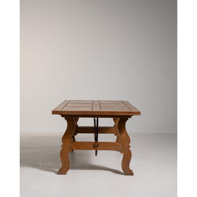 Rendered in rich wood with hand-forged iron accents, this Spanish-style table from circa 1960 France captures the robust...