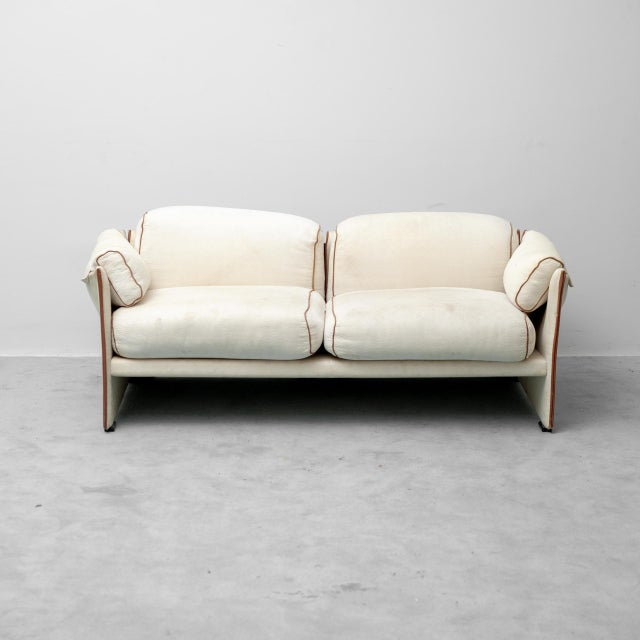 2-seater sofa. Beige fabric upholstery with brown trim. In good condition, with age-related stains, as shown in photos....