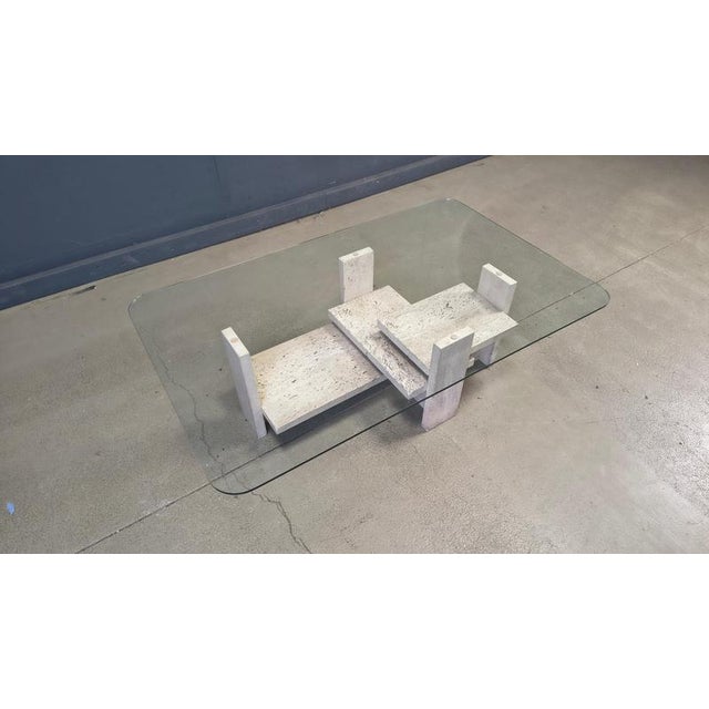 Architectural coffee table made from a solid travertine base. The table was designed by Willy Ballez. All these tables are...