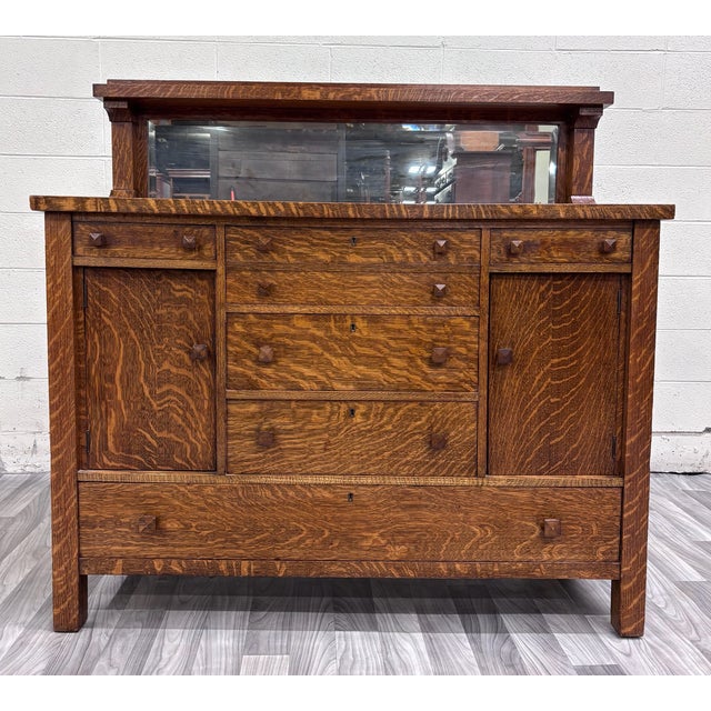 This is an exceptional antique circa 1900–1920 American Mission Arts & Crafts sideboard, buffet, or console featuring...