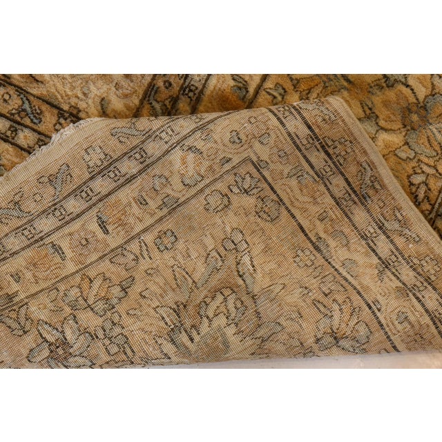 A late 19th century Persian Kerman carpet, the cream field with an allover pattern of small palmettes, cloud bands and...