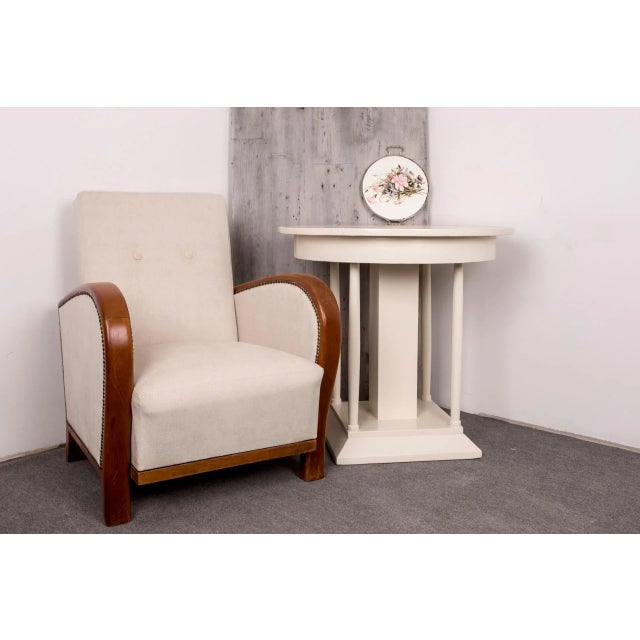 This very elegant Art Deco armchair features new cream, beige upholstery.