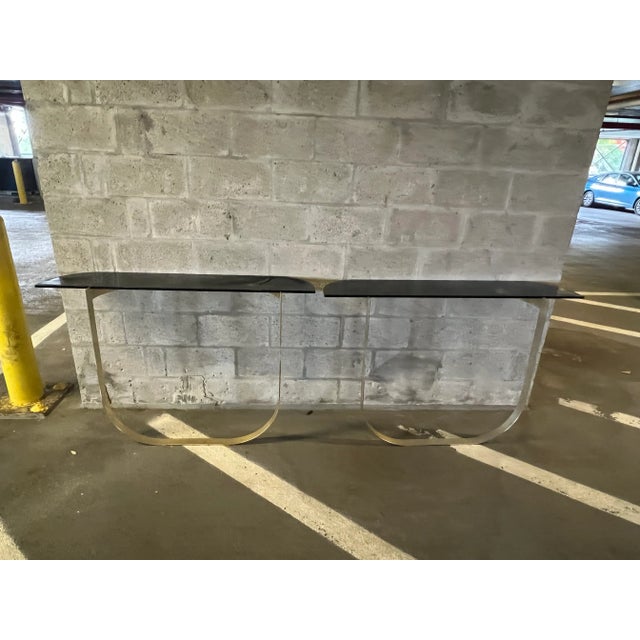 1970's Futuristic Brass and Glass Console Tables- a Pair sold as found in vintage condition without damage.