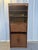 Stunning vintage bookcase in faux bamboo and woven cane, offering both beauty and utility. The piece includes two open...
