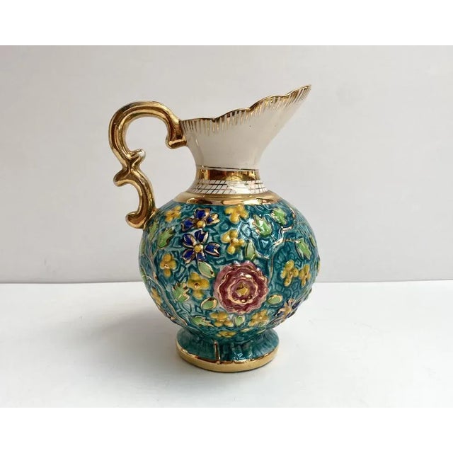 Vintage, hand painted ewer. gorgeous faience pitcher vase with a beautifull turquoise background decorated with a bright...