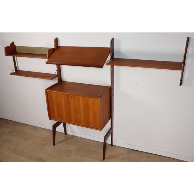 Stunning modular Scandinavian wall-mounted bookcase from the 1960s, produced by Blindheim Møbelfabrik in Norway. This wall...
