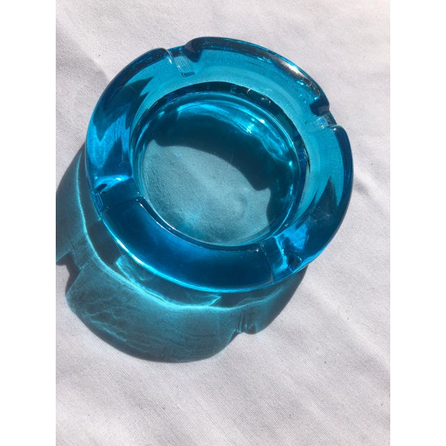 Beautiful turquoise glass ashtray. Round with 4 Butt rests. 4.75” Diameter 1” tall