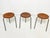 Set of three Danish teak bentwood "dot" stools with tripod legs, designed by Arne Jacobsen, circa 1960s. Seat diameter is...