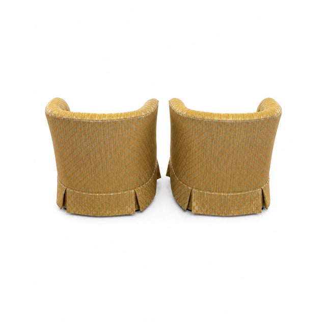 This pair of seats features vintage Mid-Century Modern barrel back swivel. They showcase a rounded, wrap-around "tub" or...