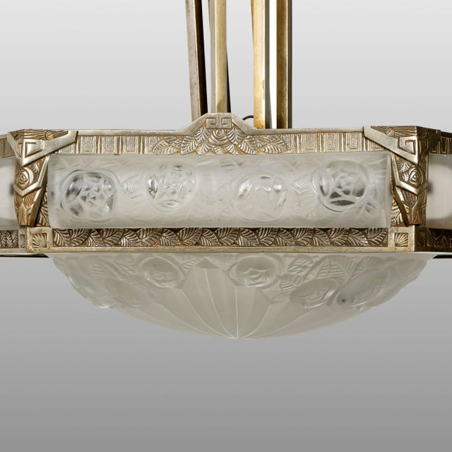 A spectacular and rare French Art Deco chandelier was created by the French artist " Degue " In a pentagon nickel bronze...