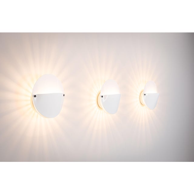 An iconic set of three "Giovi" wall lamps, designed by the legendary Achille Castiglioni in 1982 for Flos, Italy....
