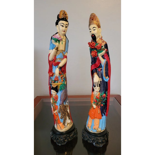 Celebrate the elegance of Chinese folk artistry with this vibrant pair of hand-painted ceramic figurines, likely...