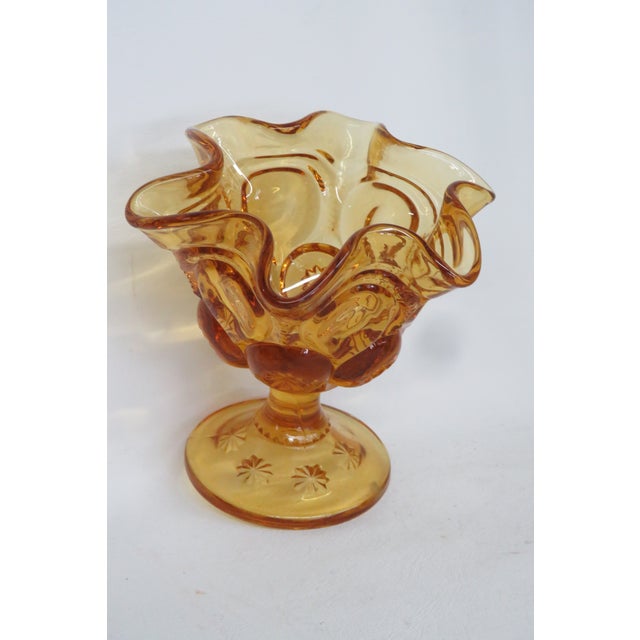 This gorgeous Compote Dish is made out of glass. This lovely piece has an exquisite honey amber color to the glass, a...