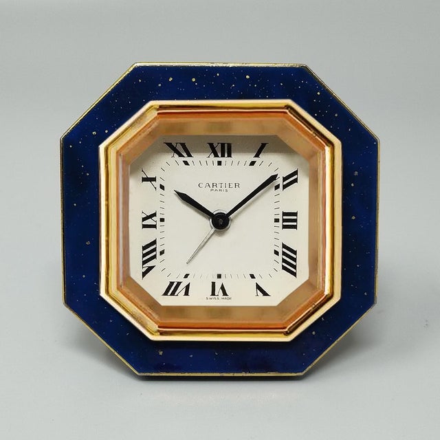 1980s gorgeous cartier alarm clock pendulette. Made in swiss. it's lapis lazuli and golden metal with manual winding....