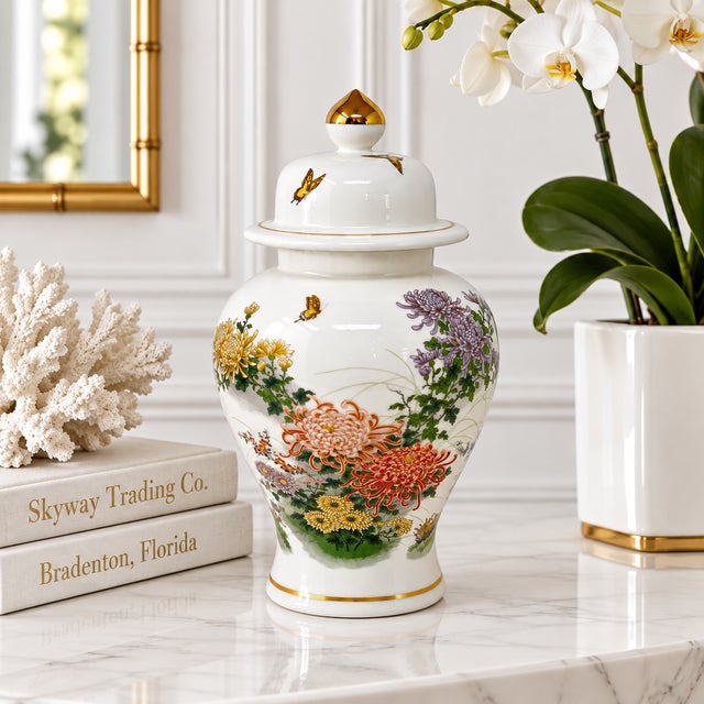 A substantial 12-inch Japanese ginger jar, decorated with butterflies, chrysanthemums and metallic gold accents. Good...