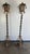 These are a pair of vintage wrought iron floor lanterns with an ornate and rustic aesthetic. The design features intricate...