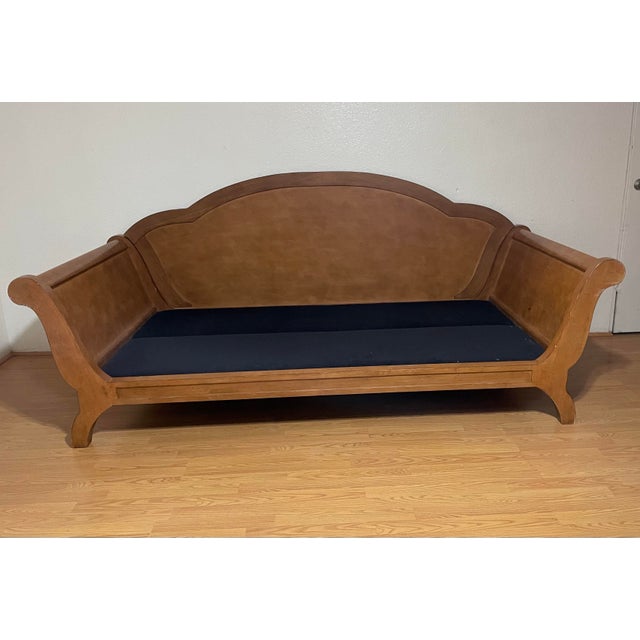 A sleigh-style wood daybed from the Cazzy Collection of Century Furniture. This wood daybed features an arched back rail,...