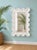 Vintage 1980s Wall Mirror made of a fiberglass / resin type material white in color with gloss surface carved look wire...