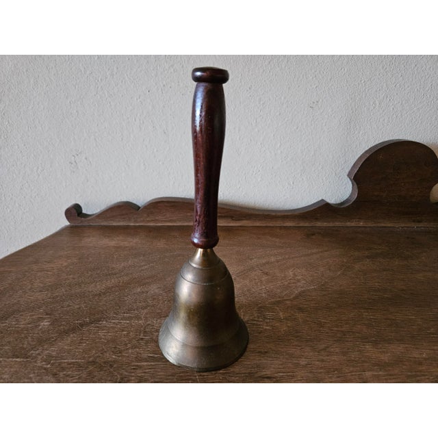 Vintage solid brass bell with wooden handle. Made in India. This bell has lots of character and patina. I often shine...
