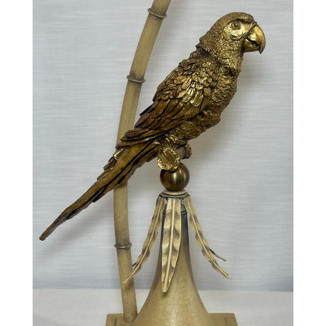 Step into a world of whimsical elegance with this stunning Vintage Hollywood Regency Gold Parrot Tole Palm Tree Table...