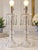 Elegant vintage pair of clear cut-glass table lamps featuring beautifully sculpted decorative bodies and cascading faceted...