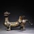 This is a striking cast bronze figurine of a winged mythical beast, featuring elaborate gold and silver inlay (gilt...