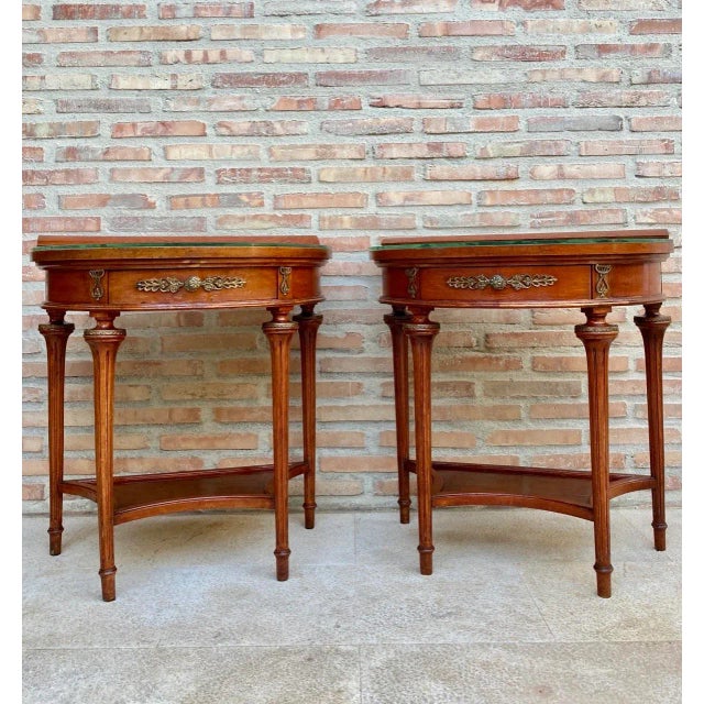 Beautiful pair of 1930s empire style mahogany nightstands. They are shaped like a half moon and two legs give elegance and...
