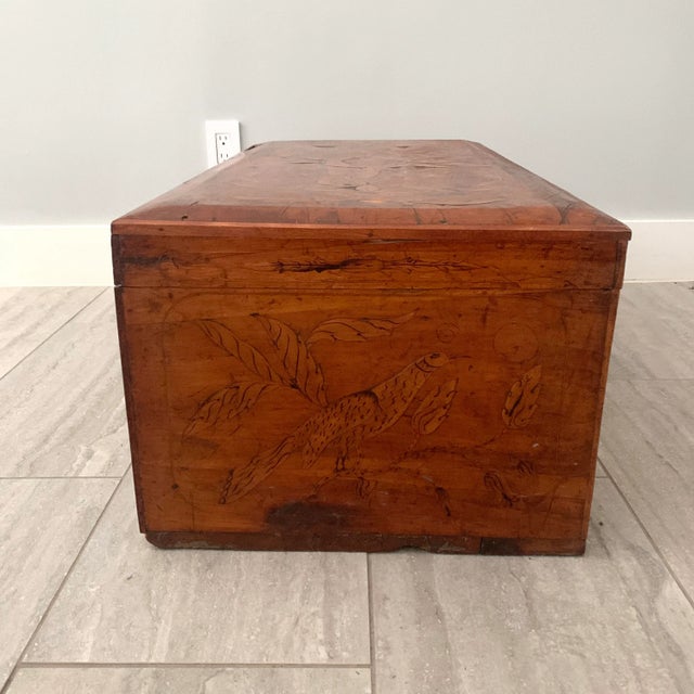 Highly decorated, handmade trunk with flowers, birds and scrollwork with some inlay. It is old and has character...a real...