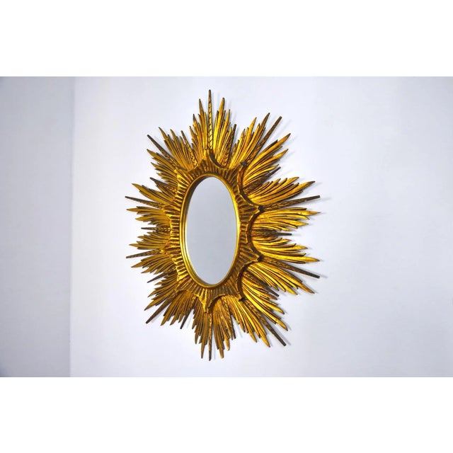 Large Golden Wood Sun Mirror, 1920s, in Very Good conditions. Designed 1920 to 1949
