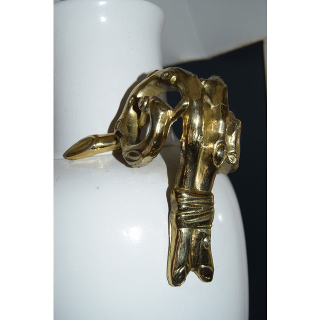 Statement-scale white ceramic urn lamp with dramatic sculptural gilt-brass handles that curl at the shoulders and drop...