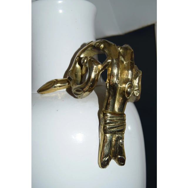 Statement-scale white ceramic urn lamp with dramatic sculptural gilt-brass handles that curl at the shoulders and drop...